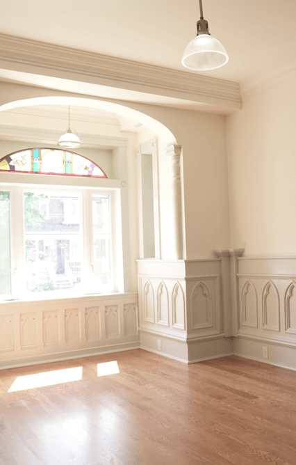 Sunny room with detailed wainscoting panels from an old church